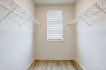 Empty room with a window and shelves on the wall.